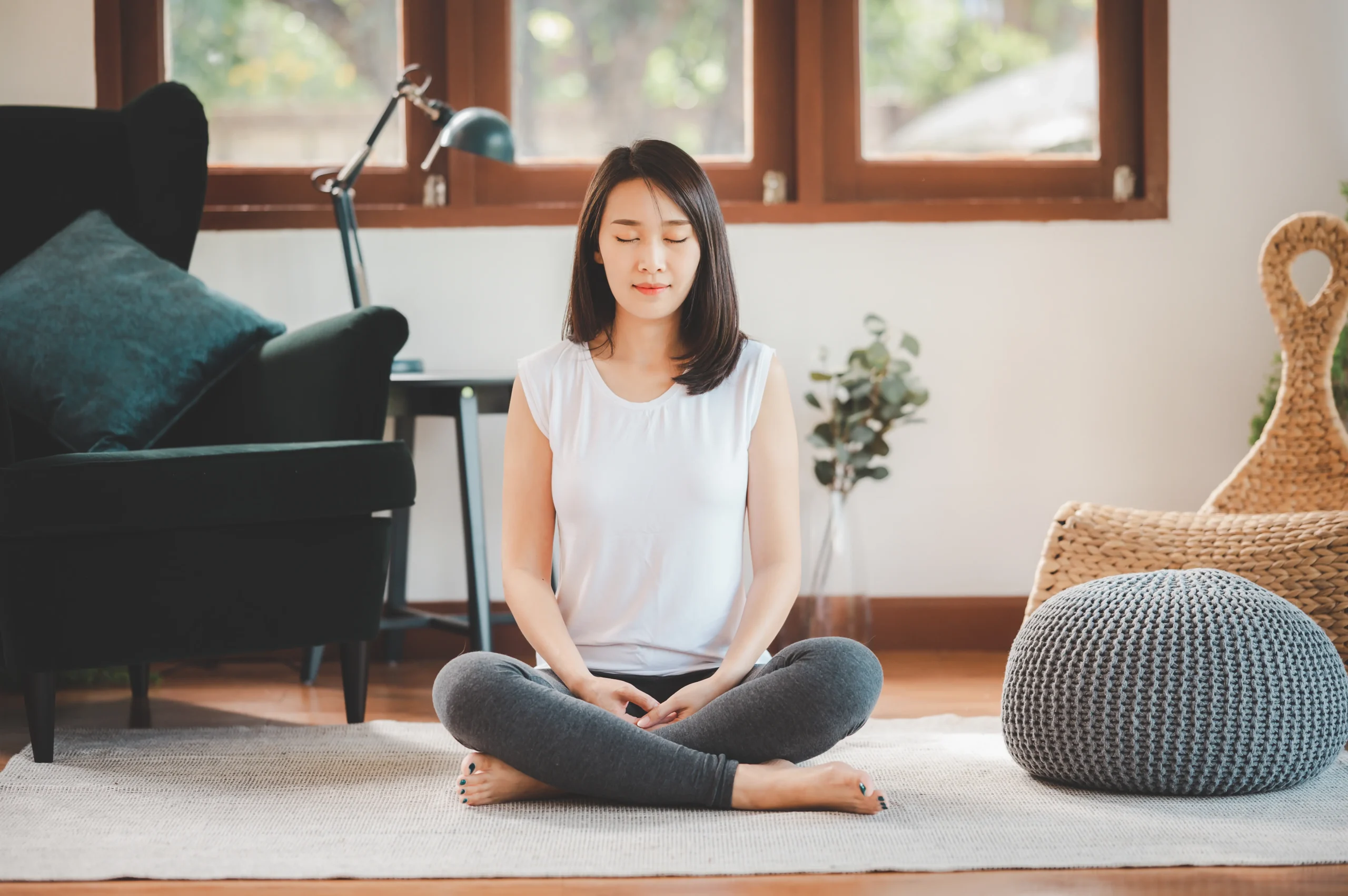 Adult practicing mindfulness and meditation skills at home as part of psychotherapy treatment in New York