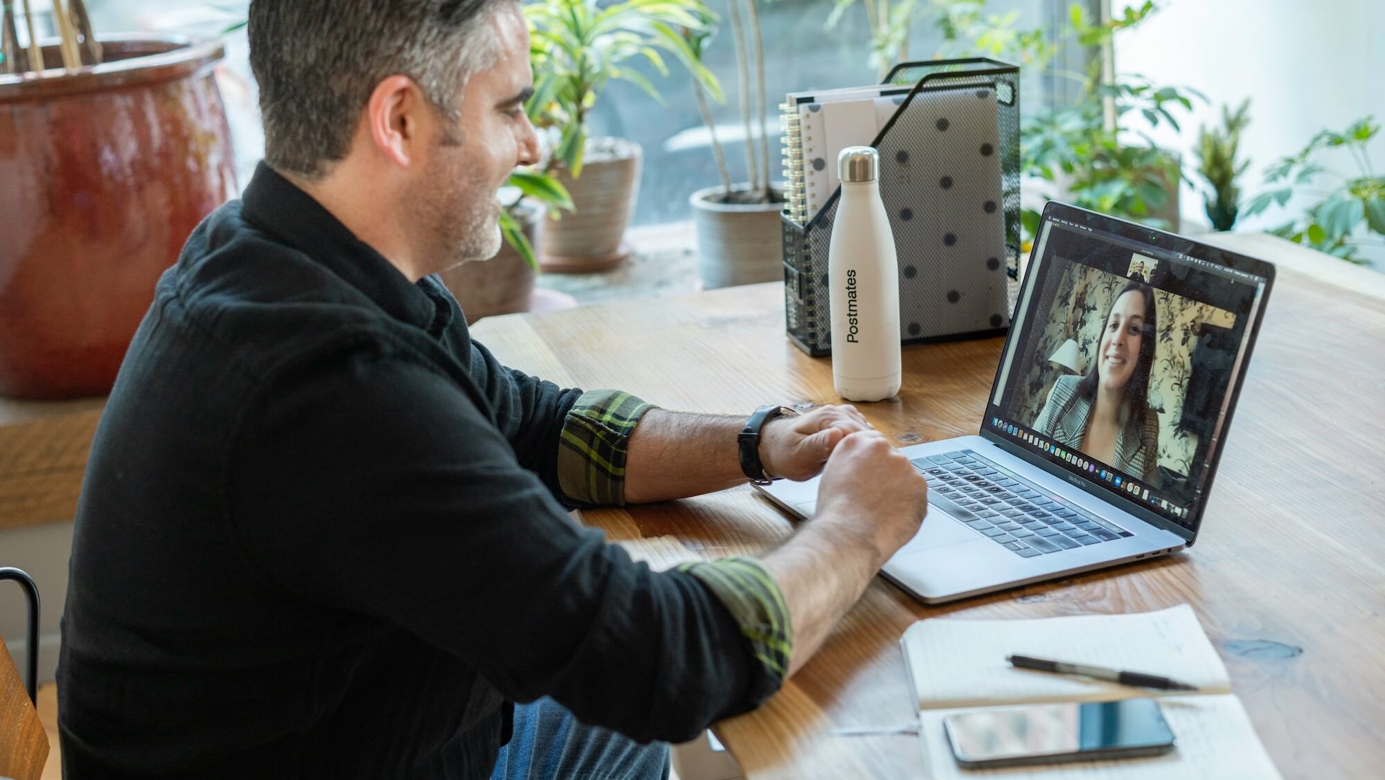 Adult male at a home desk on a video call with a therapist, illustrating what virtual cognitive rehabilitation therapy looks like