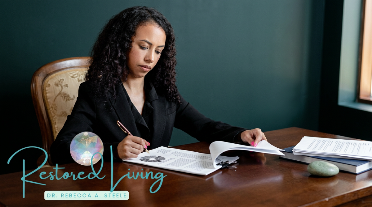 Restored Living branded image showing a professional woman seated at a desk reviewing documents in a calm, refined office setting. The Restored Living logo appears in the lower left corner.